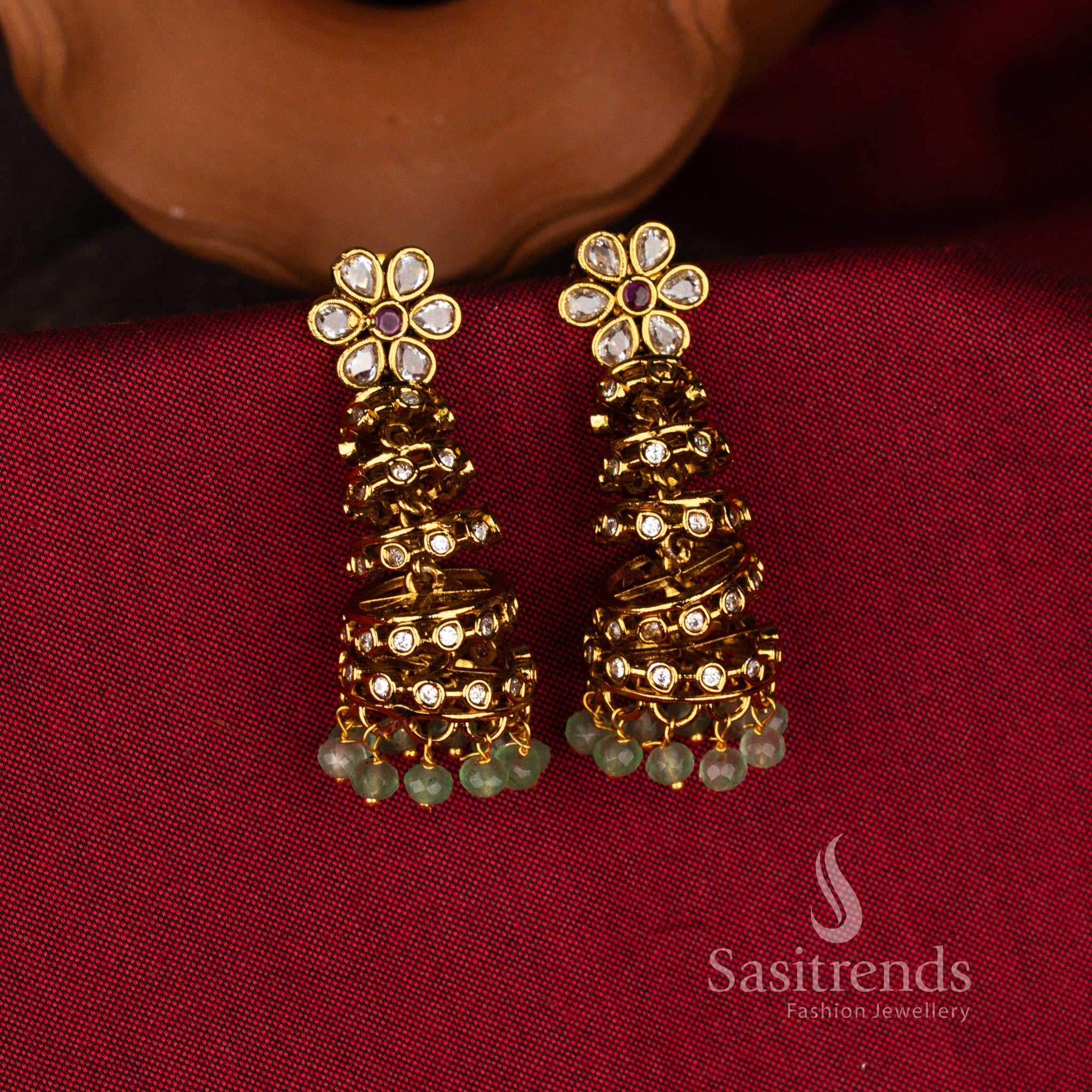 Temple Matte Gold Plated AD Stone Five-Step Layered Jhumka Earrings with Floral Stud Top and Bead Drop Fringe for Bridal Wedding & Festive Wear